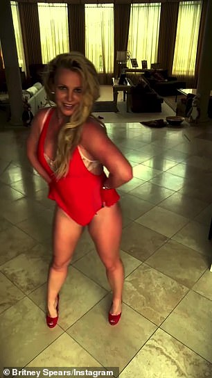 While rocking a red bathing suit with a lace bra underneath