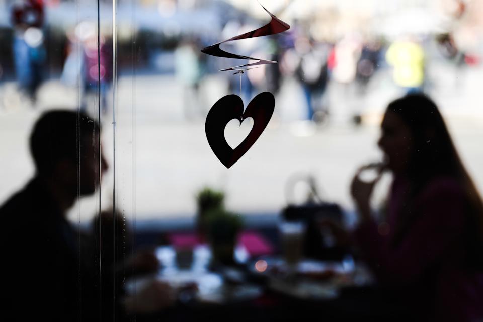 Heart-shaped decoration and a couple sitting at the table in the restaurant, the day before Valentine's Day, in Krakow, Poland on February 13, 2022 (Photo by Jacob Borzeki/Noor Photo via Getty Images)