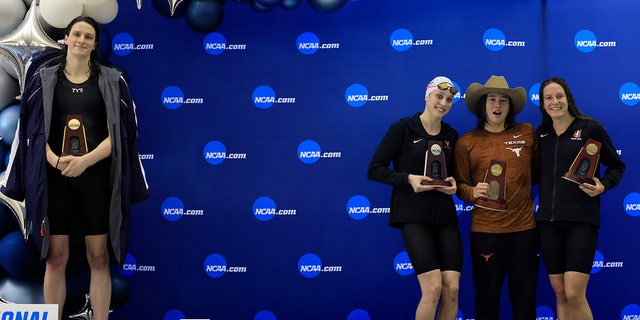 Transgender woman Leah Thomas (left) of the University of Pennsylvania poses on the podium after winning the 500-yard freestyle while medalists (LR) Emma Wyan, Erica Sullivan and Brooke Fordy pose for a photo at the Women's Division I Swimming and Diving at the NCAA Championships in March 17, 2022 in Atlanta, Georgia. 