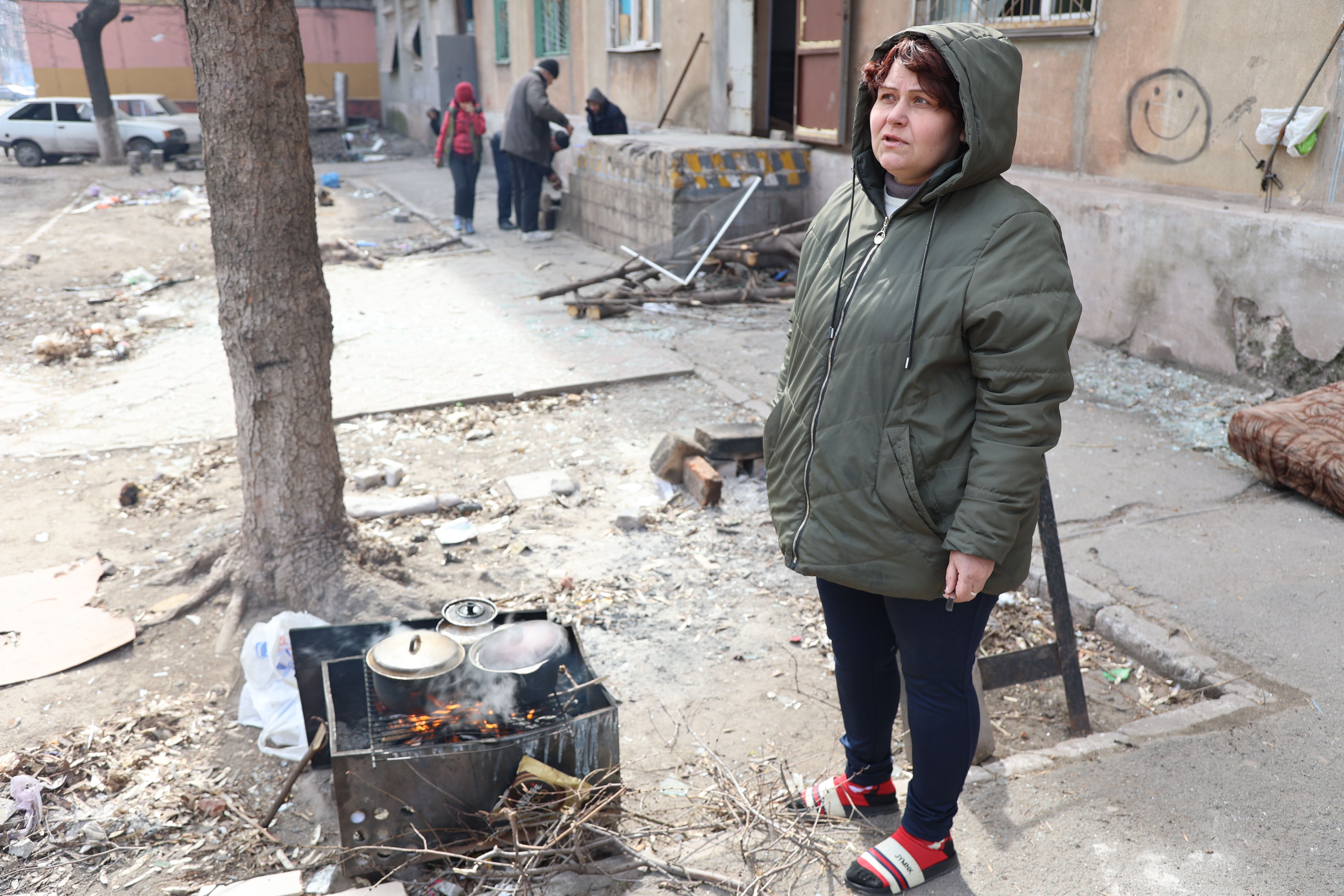 Civilians cook food amid the rubble of a bombed-out apartment in the Ukrainian city of Mariupol, which is under the control of the Russian army and pro-Russian separatists, on March 29.
