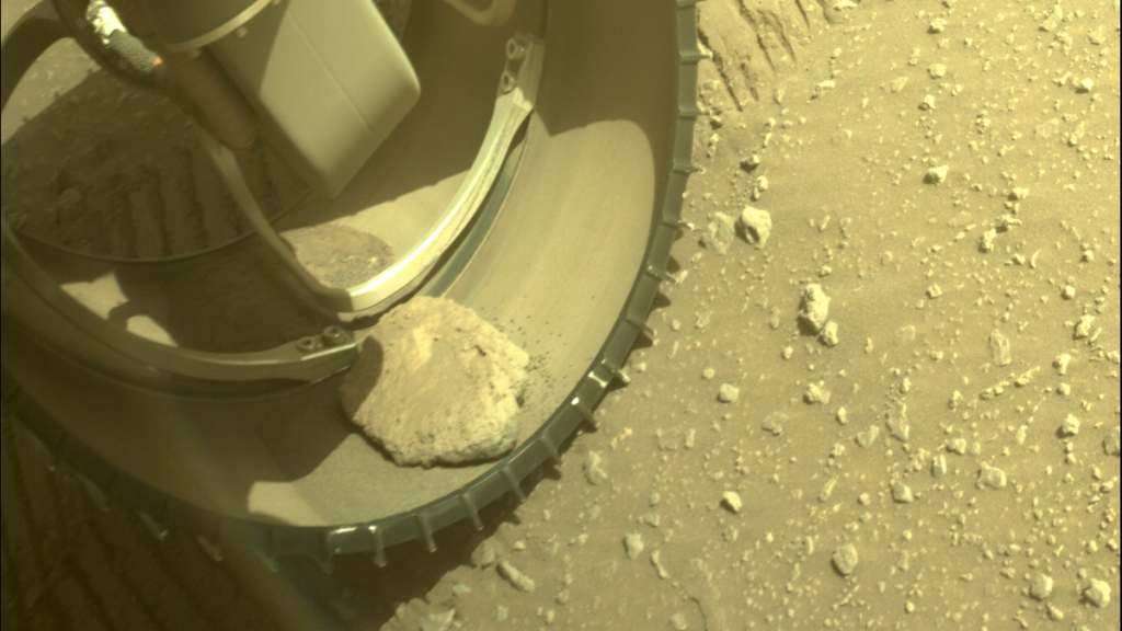 Looks like the Mars rock is stuck in the wheel of perseverance rover