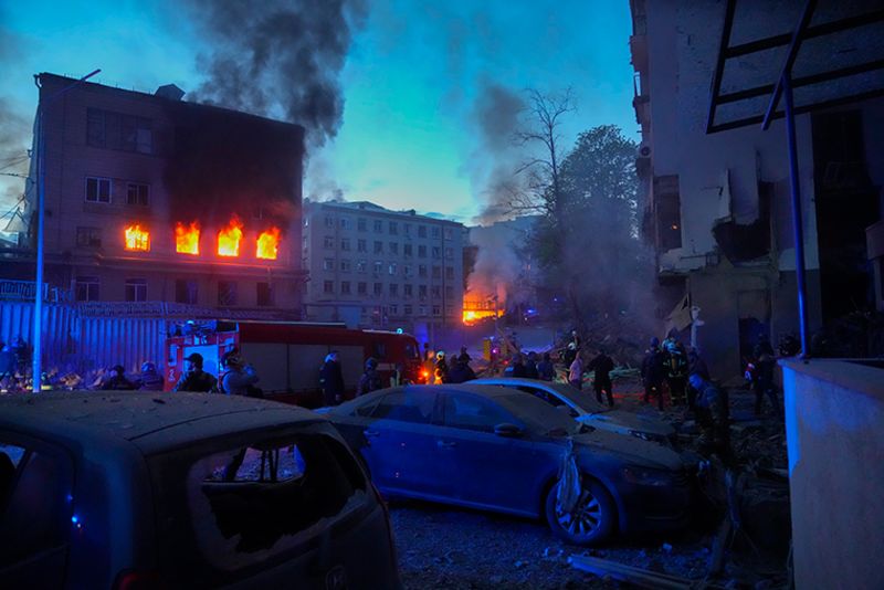 Firefighters put out a fire after a Russian rocket attack in Kyiv, Ukraine, Thursday, April 28. Russia mounted attacks across a wide area of Ukraine on Thursday, bombarding Kyiv during a visit by the head of the United Nations.