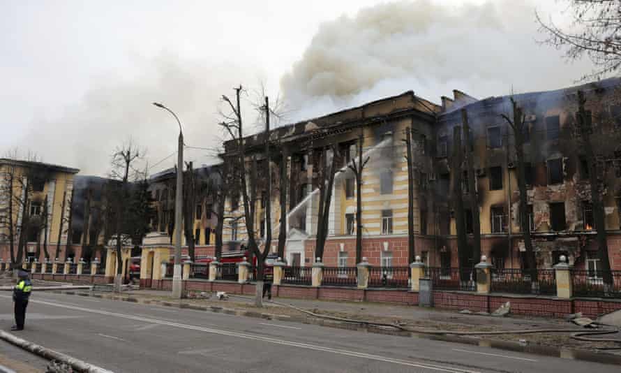 Firefighters lower the hose in the burning building of the Central Research Institute of the Air Defense Forces in the Russian city of Tver.