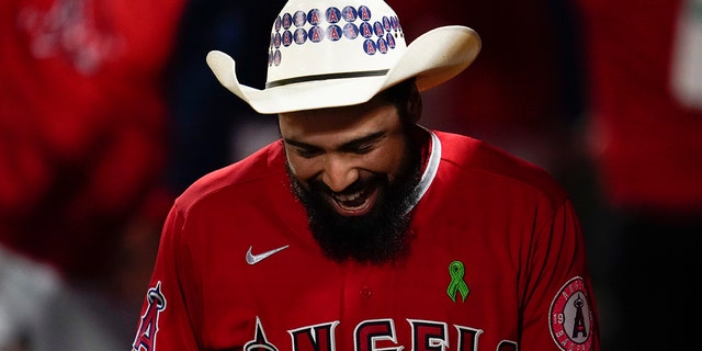 Anthony Rendon of the Los Angeles Angels celebrates in the dugout after hitting a home run against the Tampa Bay Rays in Anaheim, California, Tuesday, May 10, 2022.