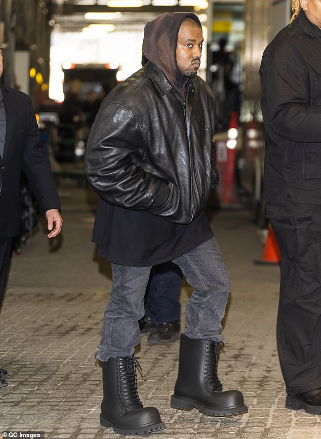 ZIPPERED: Grammy Award winner, 44th wore a Balenciaga XXL black leather hoodie and lace-up booties over jeans as he walked out of the luxury brand's Spring 2023 fashion show