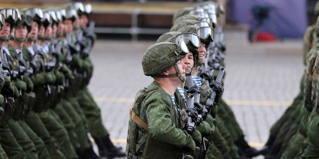 Russian service personnel walk during a military parade marking the 77th anniversary of the victory over Nazi Germany in World War II, on Red Square in central Moscow, May 9, 2022.