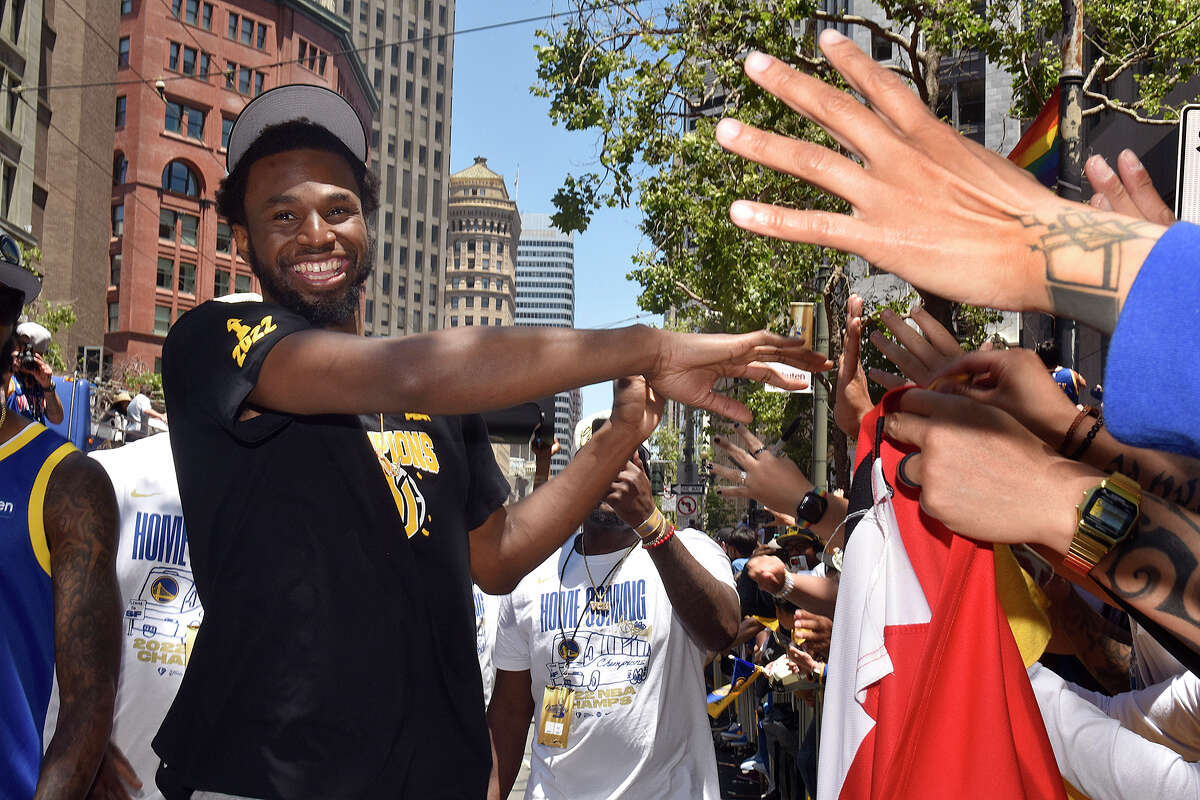 Warriors star Andrew Wiggins leaves his bus to interact with fans on Market Street, during the Victory Parade on Monday, June 20, 2022. 