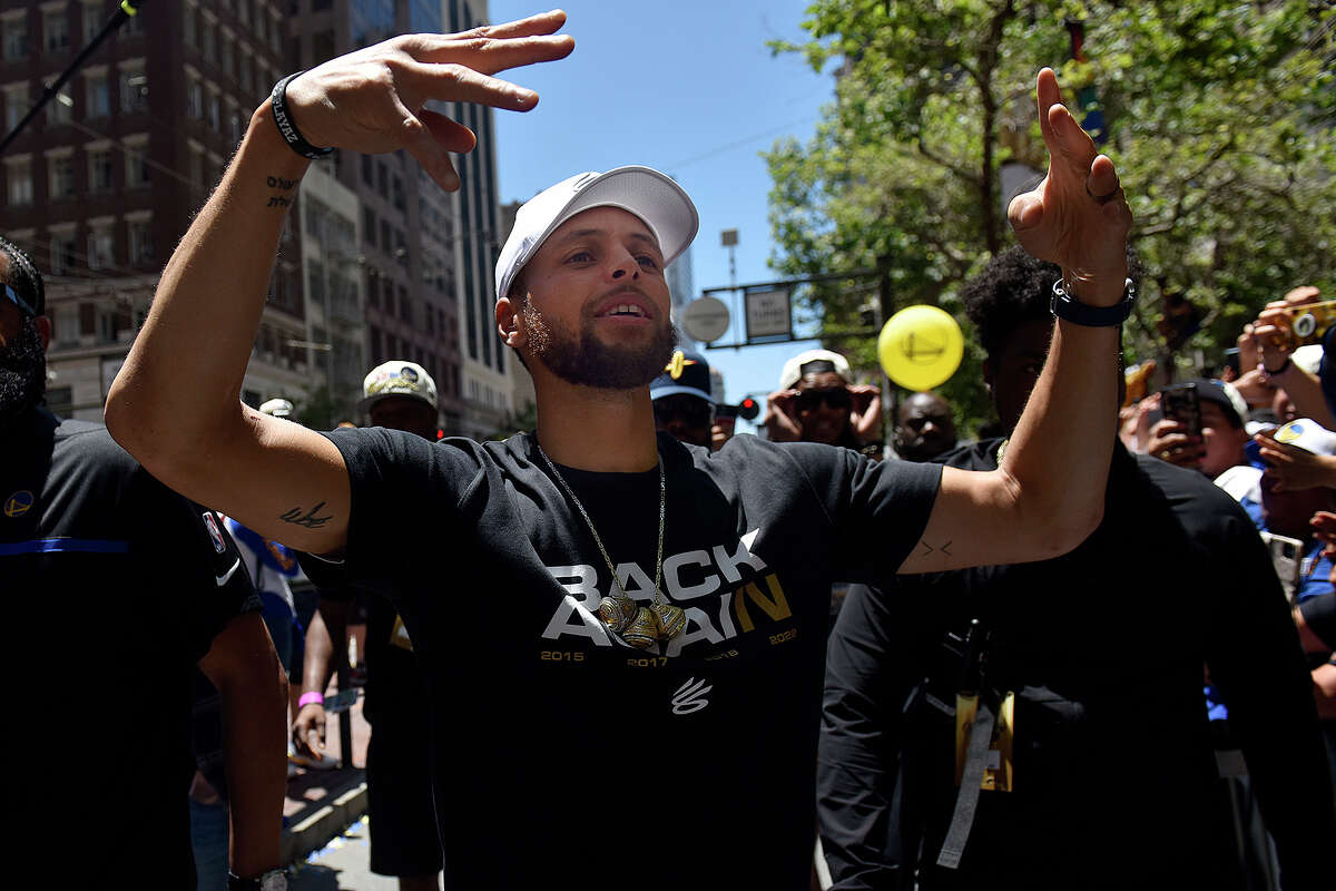 Stephen Curry leaves his bus during the Warriors Triumph Parade to interact with fans on Market Street. 