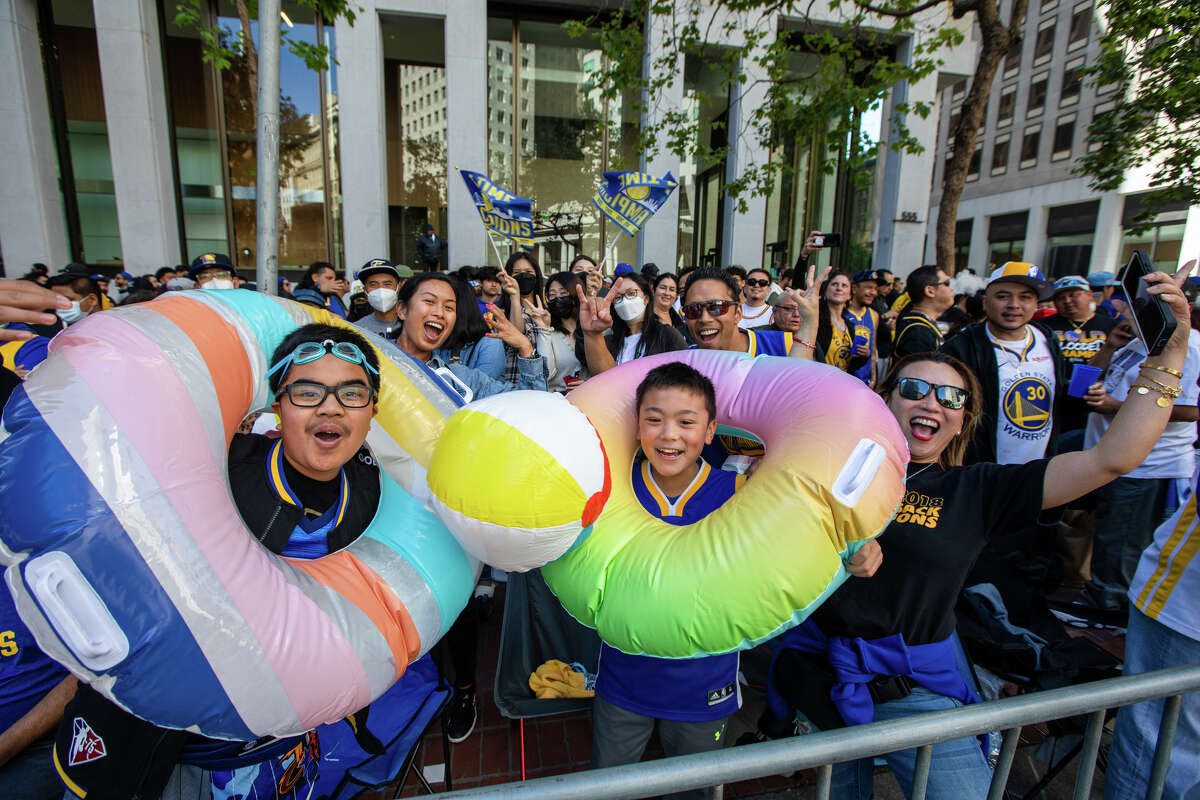 A couple of fans are enjoying "pol party" During the Golden State Warriors Championship Parade at Market Street in San Francisco, California on June 20, 2022.