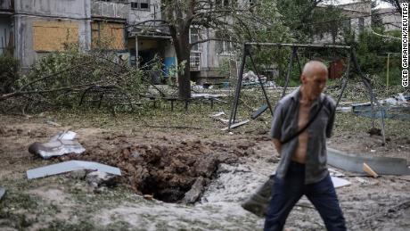 A local resident walks past an apartment building destroyed in a missile strike, amid Russia's invasion of Ukraine, in Bakhmut, Ukraine, June 13, 2022. 