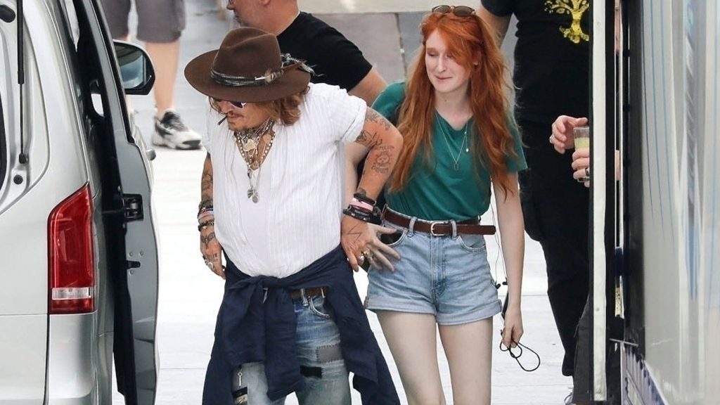 Johnny Depp continues his concerts in Italy, with a cute red head in the clouds