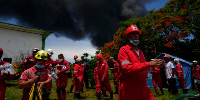 Members of the Cuban Red Cross prepare to move to Matanzas Supertanker Base, as firefighters work to put out a fire that broke out during a thunderstorm the night before, in Matazanas, Cuba, Saturday, August 6, 2022.