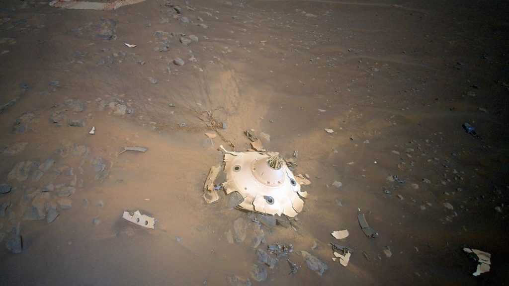 This image of Perseverance’s backshell sitting upright on the surface of Jezero Crater was collected from an altitude of 26 feet (8 meters) by NASA’s Ingenuity Mars Helicopter during its 26th flight at Mars on April 19, 2022.