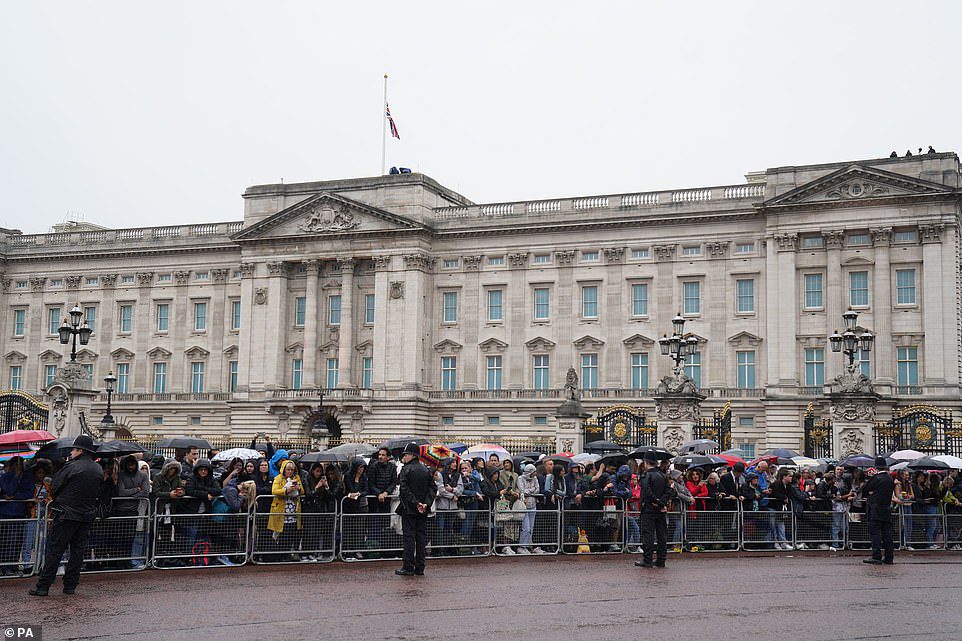 Crowds gather outside Buckingham Palace, waiting to see the Queen's coffin