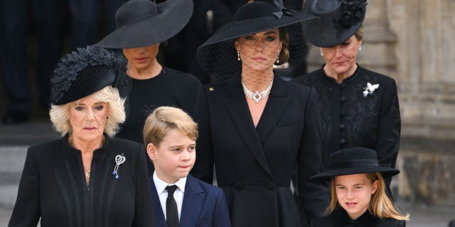 (LR) Camilla, Queen Consort, Meghan, Duchess of Sussex, Prince George of Wales, Catherine, Princess of Wales, Princess Charlotte of Wales and Sophie, Countess of Wessex during the state funeral of Queen Elizabeth II at Westminster Abbey on September 19, 2022 in London. 