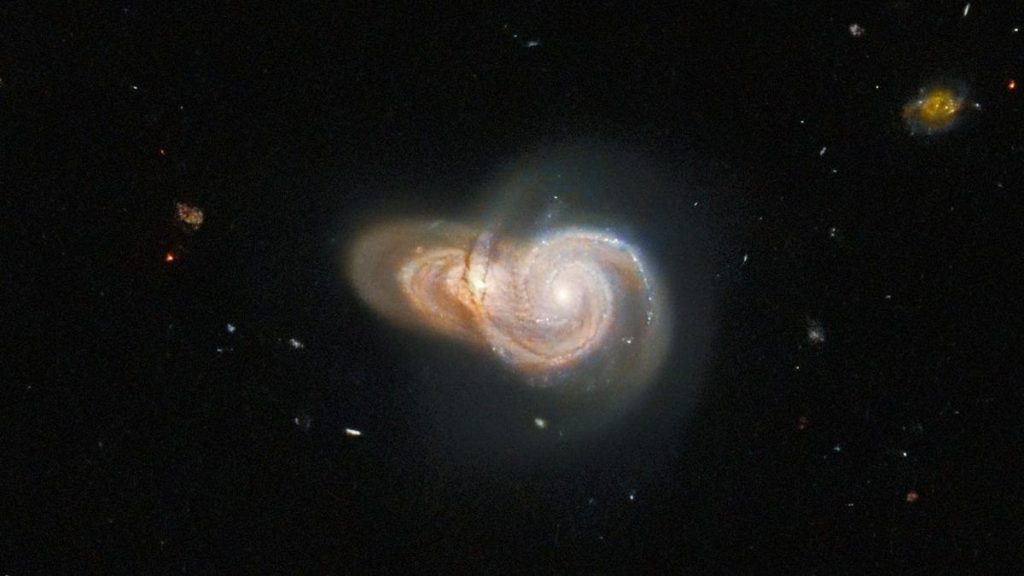 These two "colliding" galaxies paint a wonderful double picture