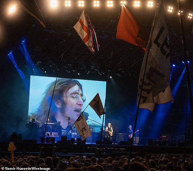 Opening: Earlier this year, Julian told how difficult it was to watch his father's posthumous performance at Glastonbury with former teammate Sir Paul.