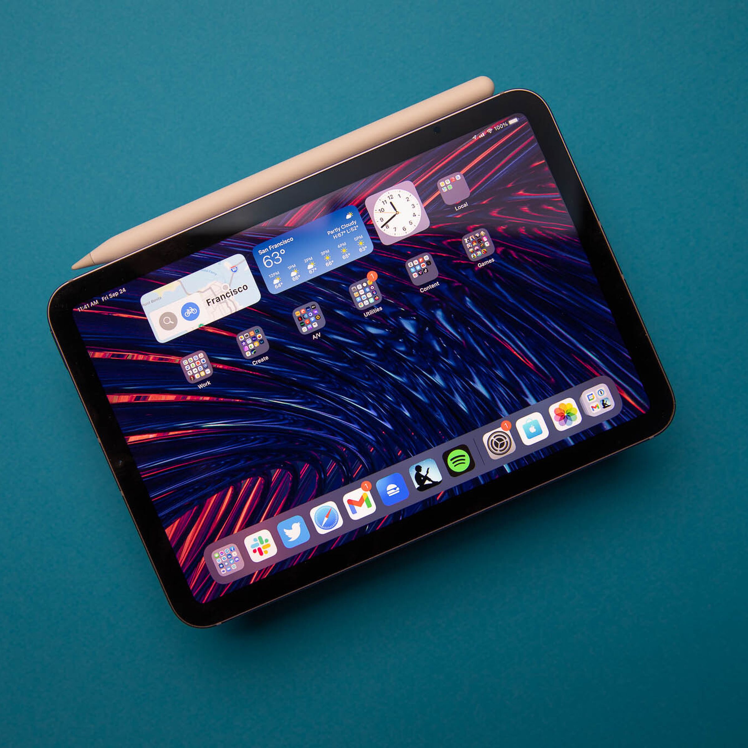 Image of the 2021 iPad mini with the included second-generation Apple Pencil on a blue background