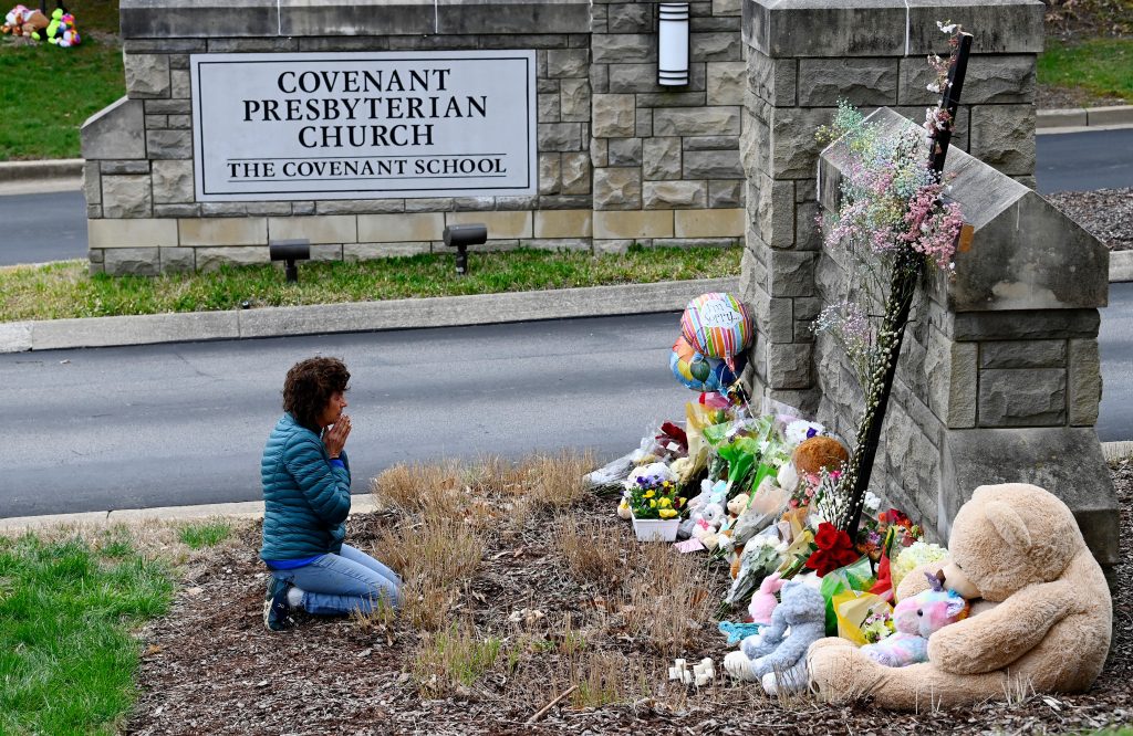 A mourner greets the six victims of Monday's school massacre.