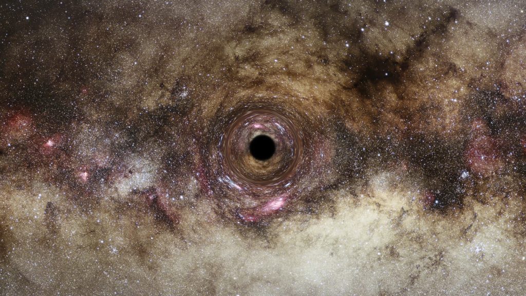 Gravitational light-bending reveals one of the largest black holes ever discovered