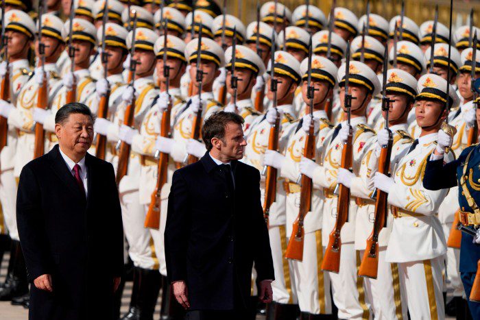 Xi Jinping and Emmanuel Macron inspect the guard of honor in Beijing