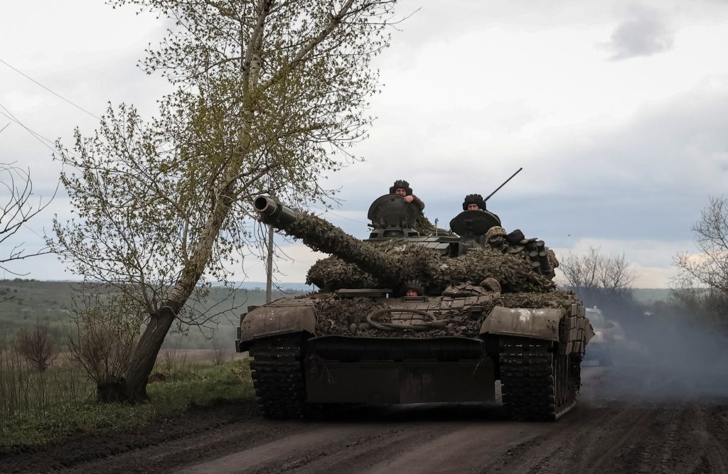 Ukrainian soldiers ride a tank along a road in the town of Chasev Yar, amid a Russian offensive into Ukraine, near a front line in Donetsk region, Ukraine April 22, 2023.
