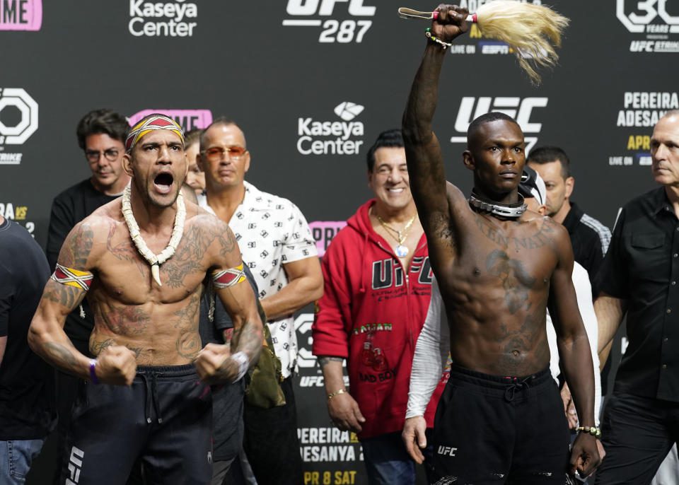 UFC 287 Middleweight Champion Alex Pereira, left, and Israel Adesanya face the crowd after a ceremonial weigh-in on Friday, April 7, 2023, in Miami.  Pereira will defend his title against Adesanya on Saturday.  (AP Photo/Marta Lavandier)