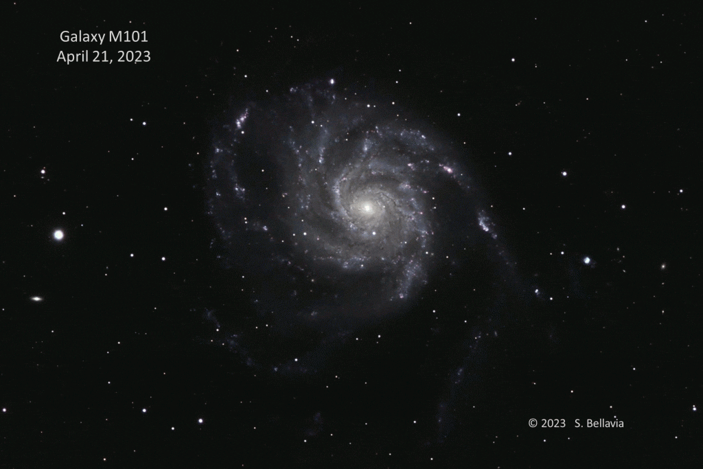 an animation showing a bright star explosion appearing in a spiral galaxy