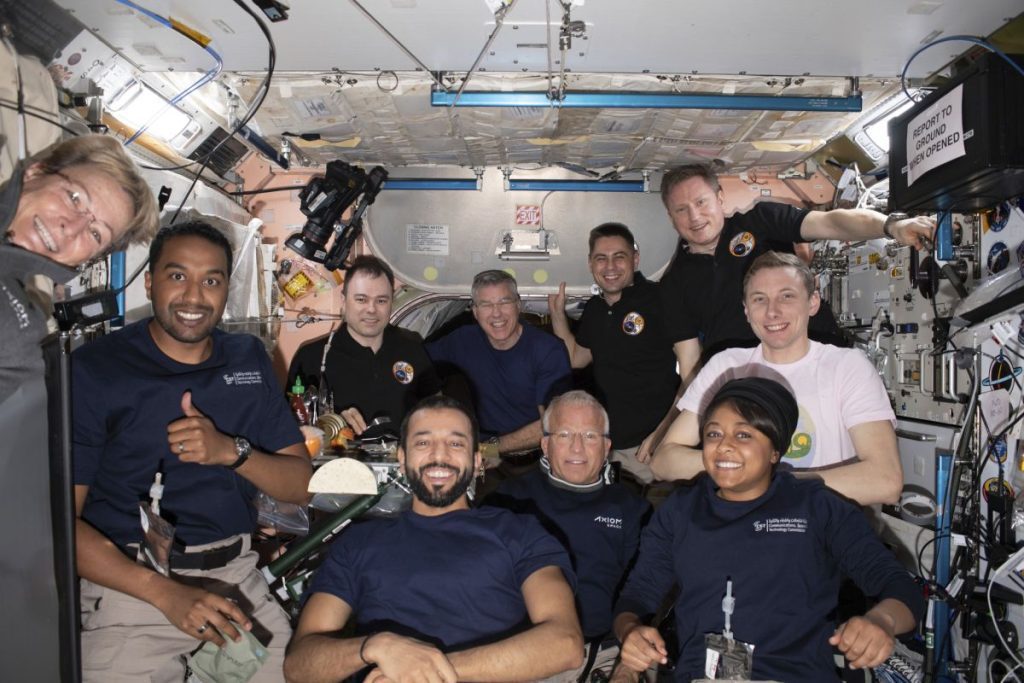 11 astronauts packed together on the international space station