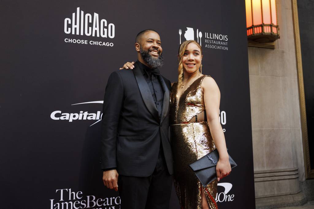 Damar Brown, left, of Virtue, walks the red carpet as he attends the James Beard Awards Gala at the Lyric Opera House on June 5, 2023.