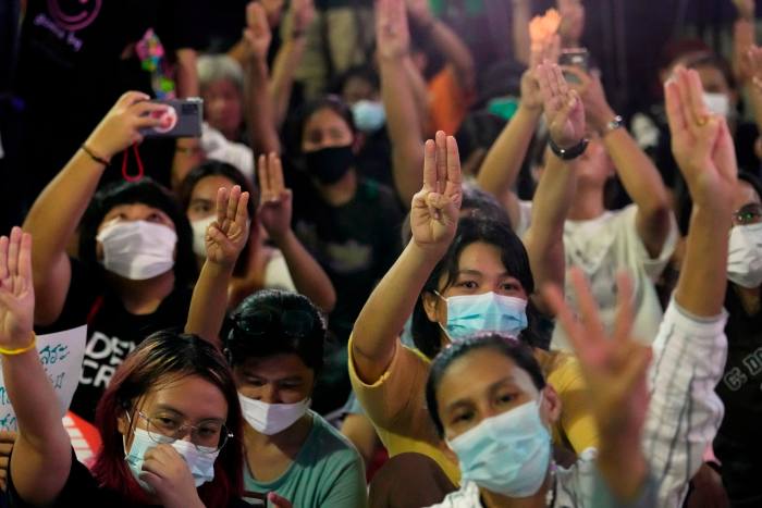 Supporters of Peta Limjaronrat's Movement Forward party raise a three-fingered salute, symbol of resistance, during a protest in Bangkok on Wednesday.