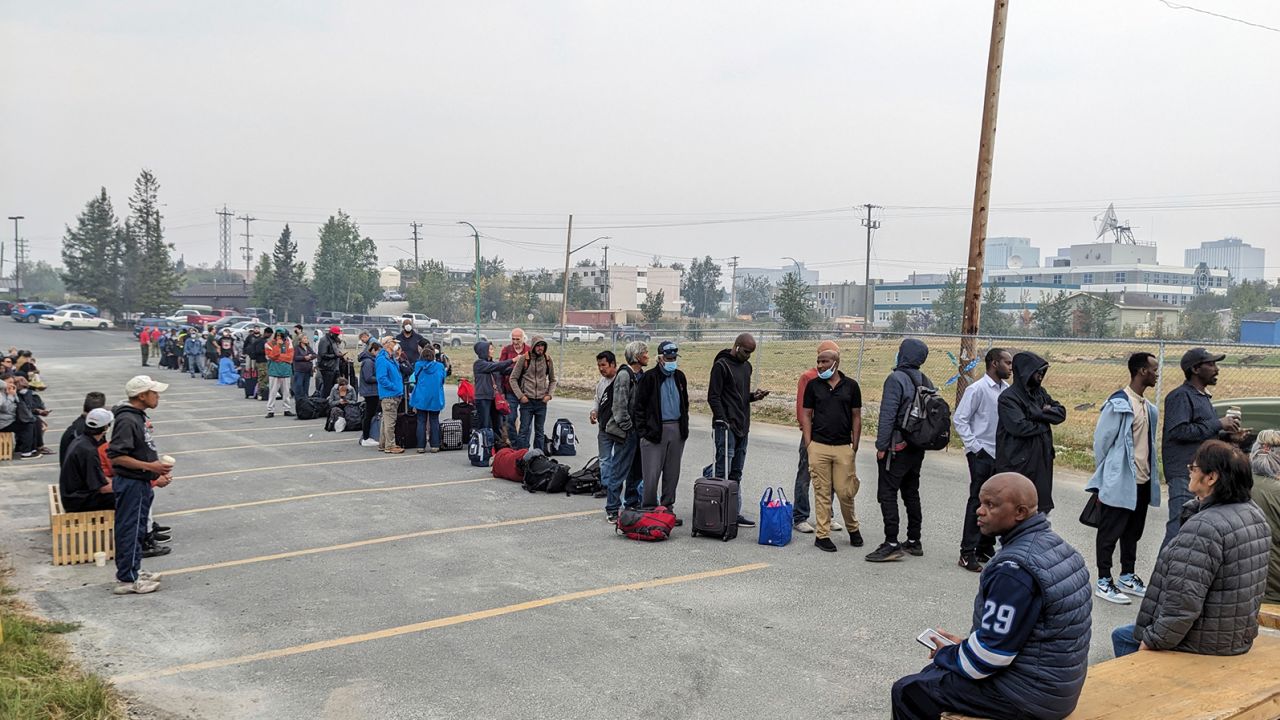 People line up in Yellowknife to sign up for an evacuation flight on August 17. 
