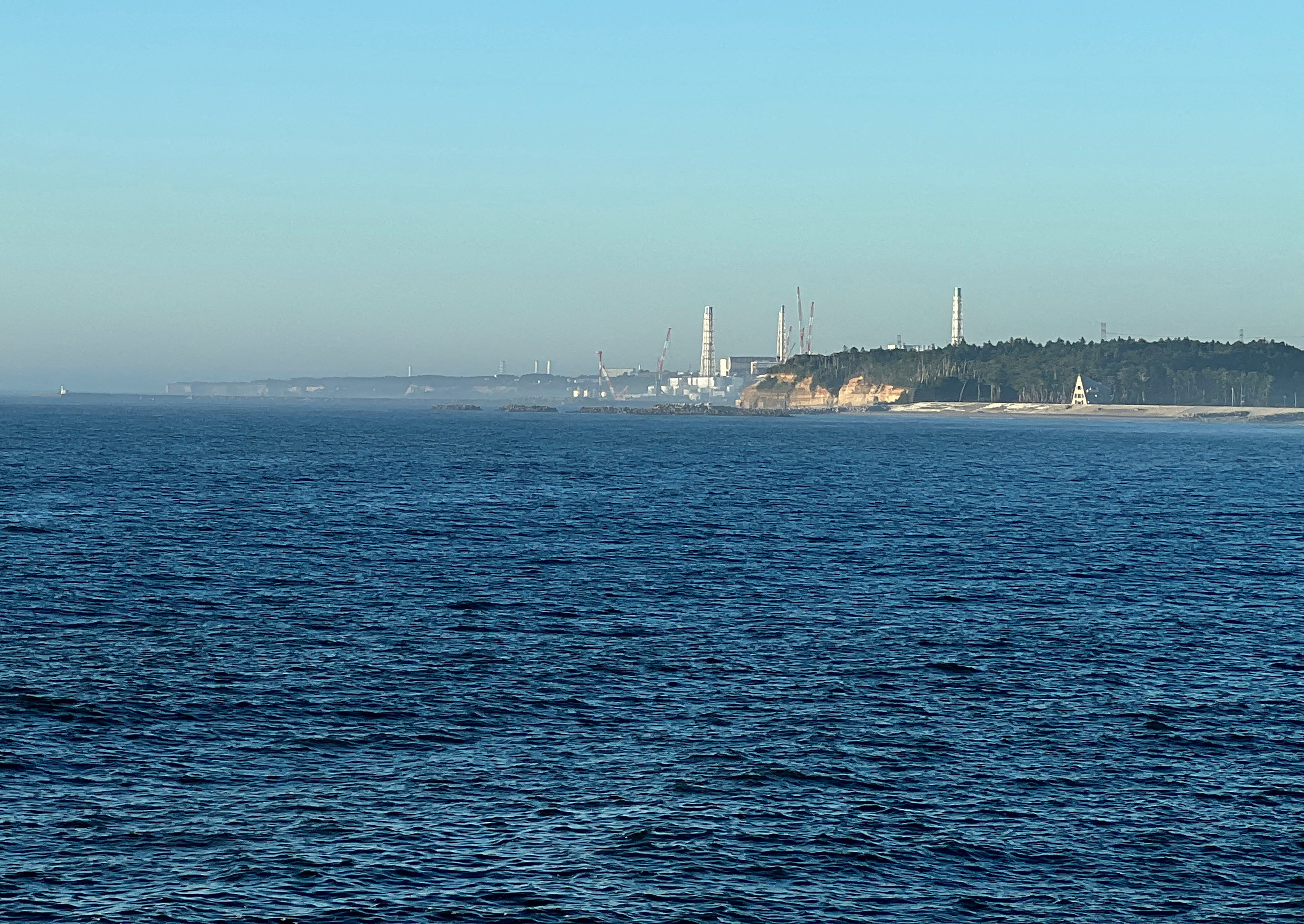 A view of the Fukushima Daiichi Nuclear Power Plant from the nearby fishing port of Okido in the town of Nami
