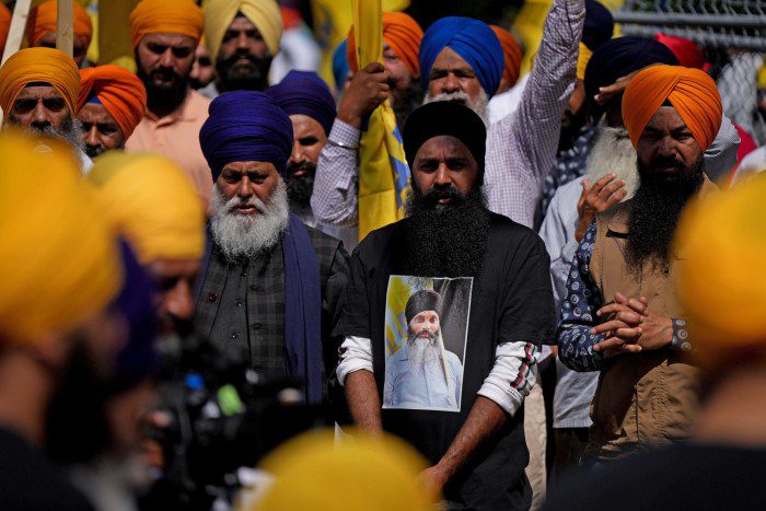 One of the mourners wears a T-shirt bearing the image of Hardeep Singh Nigar 