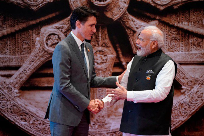 Justin Trudeau and Narendra Modi shake hands