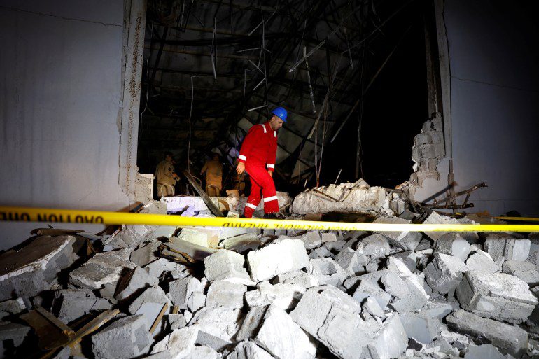 An emergency worker walks over rubble at the site after a deadly fire at a wedding party, in the Hamdaniyah district of Iraq's Nineveh Governorate, Iraq, September 27, 2023. REUTERS/Khaled Al-Mousili