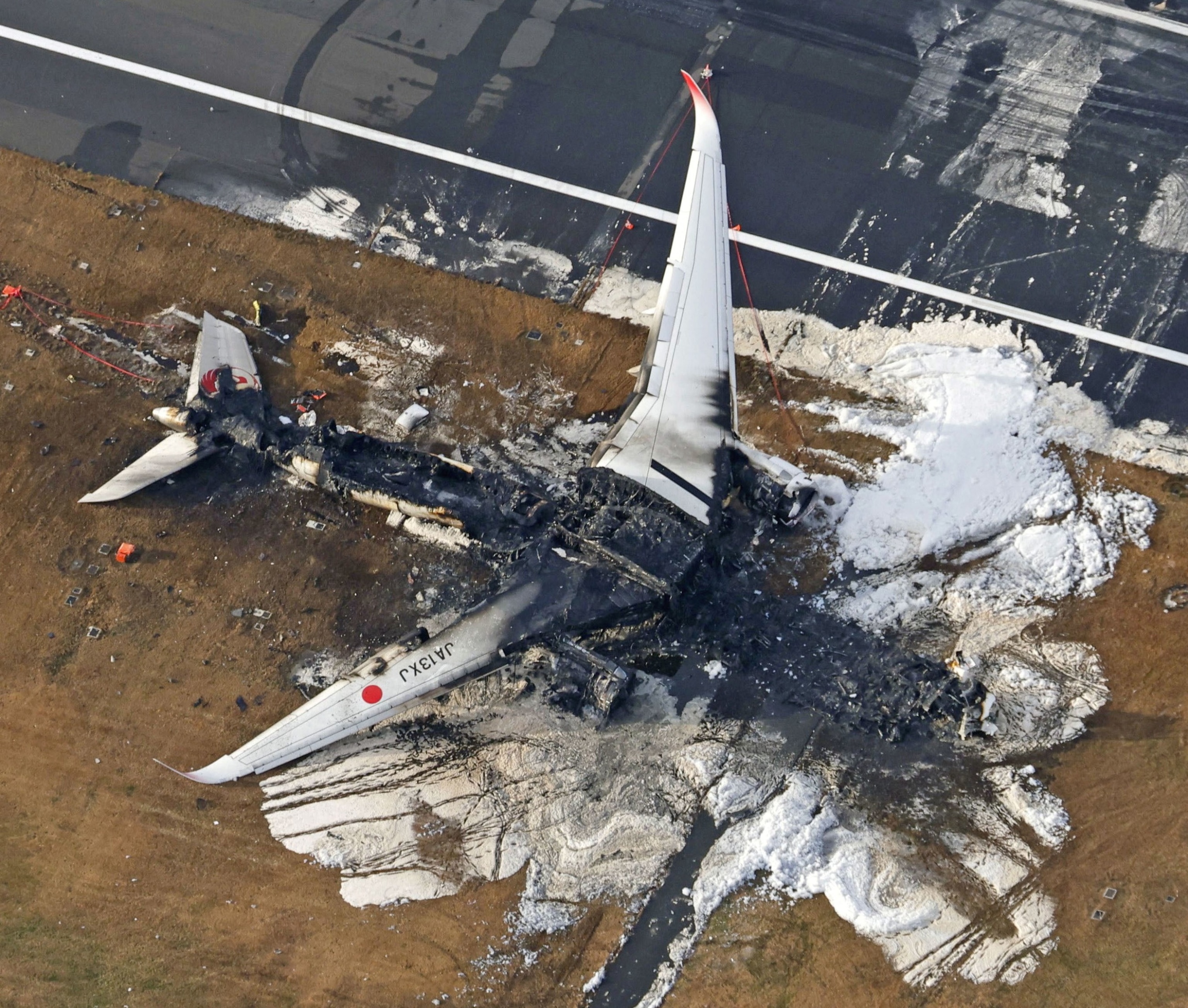 Image: An aerial view shows a burning Japan Airlines Airbus A350 after colliding with a Japan Coast Guard plane at Haneda International Airport in Tokyo, Japan on January 3, 2024.