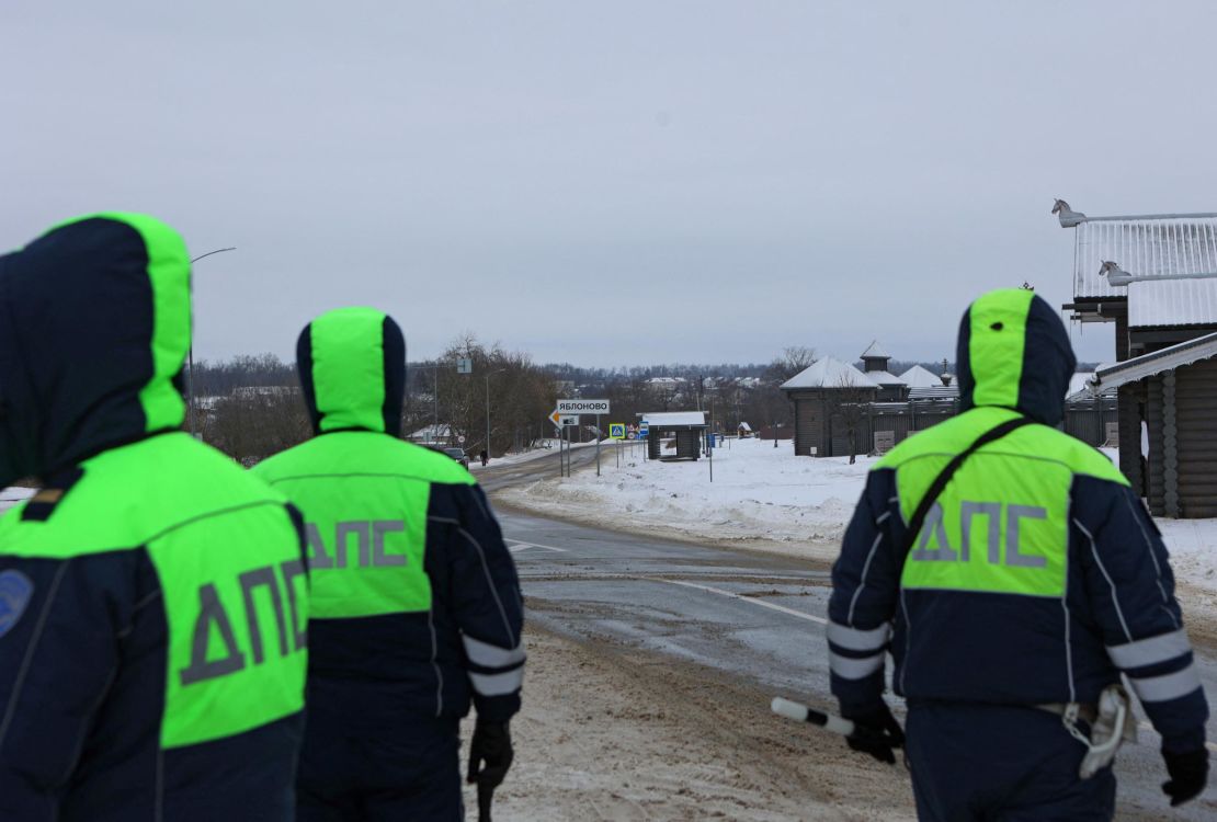 Traffic police officers block a road near the crash site of the Russian military transport plane Ilyushin Il-76 outside the village of Yablonovo in Belgorod region, Russia, January 24, 2024.