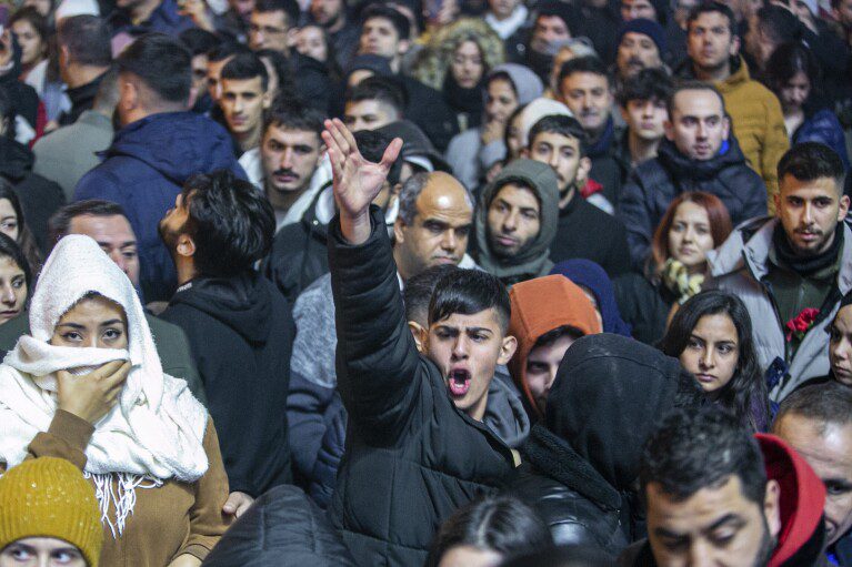 A man chants slogans during a gathering to commemorate the first anniversary of the catastrophic earthquake that struck the country, in the city of Antakya, southern Turkey, Tuesday, February 6, 2024. (AP Photo/Metin Yoksu)