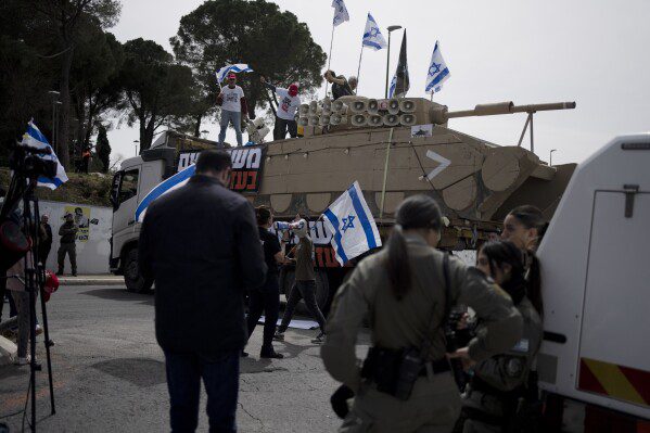 Members of the Brothers and Sisters in Arms organization protest against Israel's exemptions for ultra-Orthodox Jews from mandatory military service, near the Prime Minister's Office in Jerusalem, Tuesday, March 26, 2024. (AP Photo/Maya Alleruzzo)