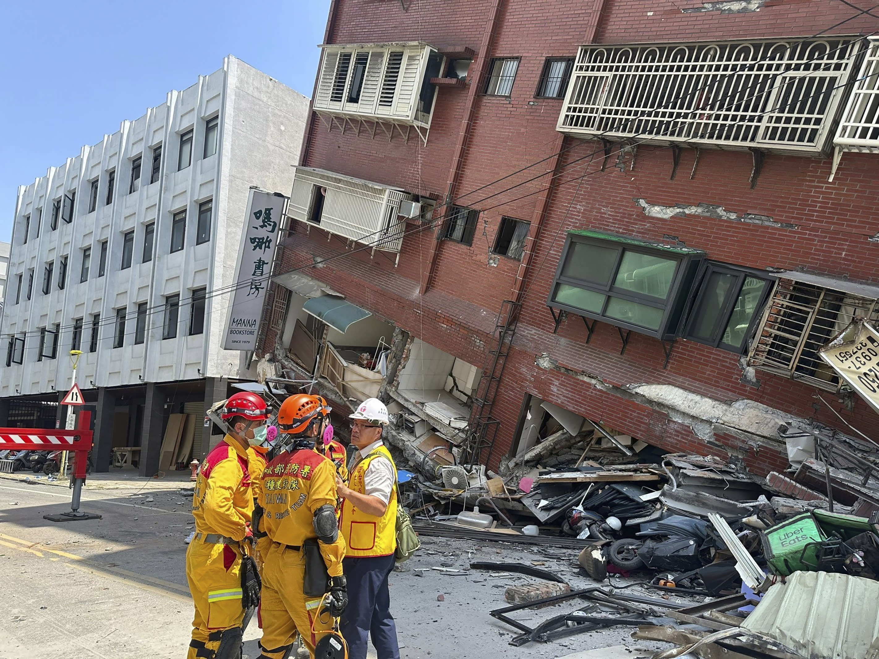 Members of a search and rescue team gather outside a lean-to building in Hualien City.