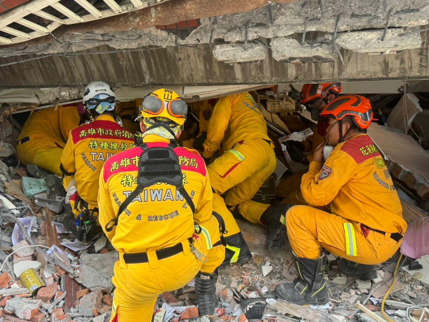 Rescue workers search for survivors under the rubble of a collapsed building in Hualien City.