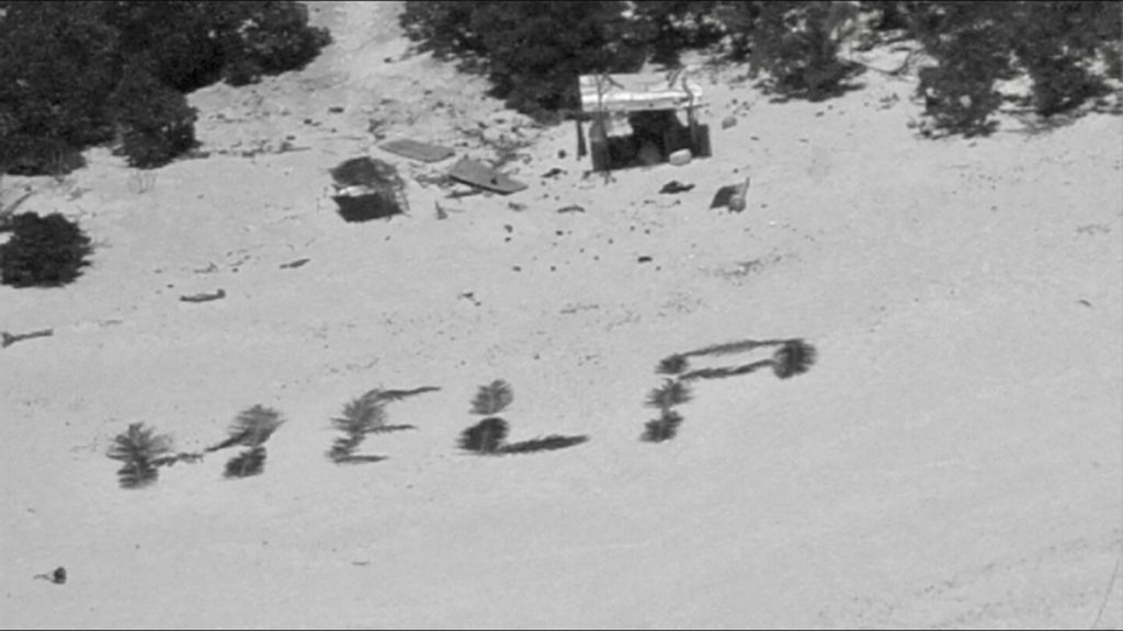 "Help" sign on shore posts for Navy and Coast Guard pilots for men stranded on a Pacific atoll